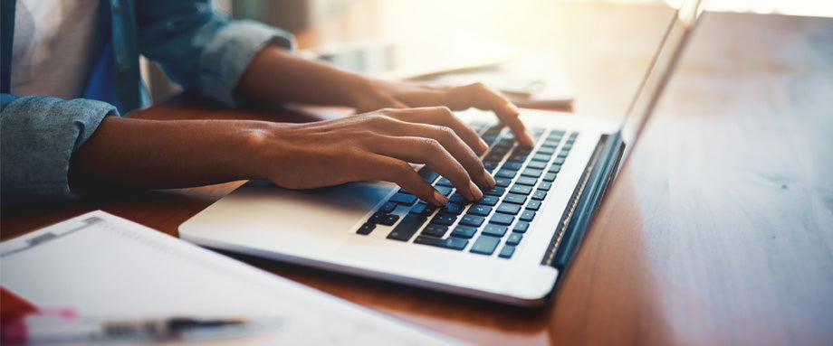 Hands typing on a keyboard