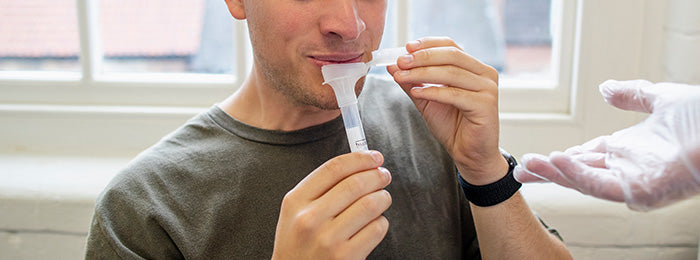 Patient giving a saliva test